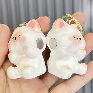 Magnetic cat couple keychains in white with pink details and gold rings for lovers