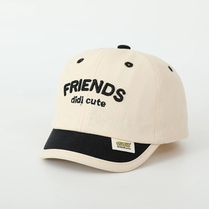 Detail of embroidered Friends logo and contrast binding on kids baseball cap brim