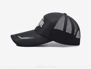 Detail view of the breathable mesh back and Adventure logo on the black trucker hat