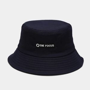 Close-up of navy blue cotton bucket hat featuring THE FOCUS embroidery patch