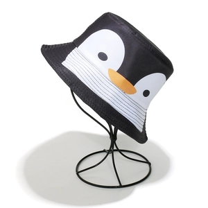 Close-up of the cartoon penguin face embroidery and fabric texture on a black bucket hat