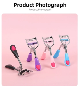 Detailed view of portable stainless steel eyelash curlers with colorful heart handles