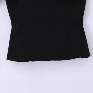 Close-up of black tube top hem showing high-quality woven fabric texture and stitching