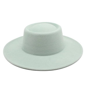 Macro view of mint green wool felt fedora showing its stiff texture and wide brim
