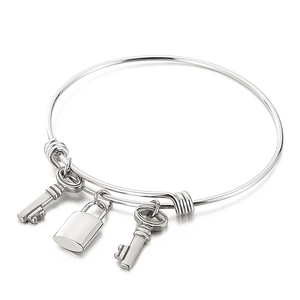 Polished stainless steel wire bangle with lock and key charms in silver finish