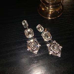 Silver drop earrings with long crystal pendants and vintage baroque style design