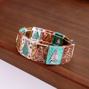 Detail of vintage elastic bracelet with rectangular embossed turquoise and bronze charms