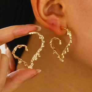 Modern gold irregular lava heart stud earrings with a liquid metal texture finish