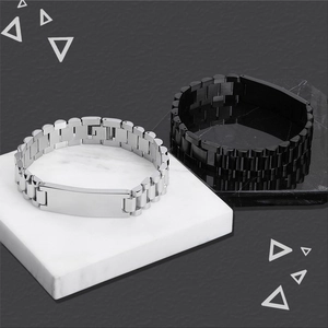 Detail of silver and black stainless steel watch-band style ID bracelets on marble blocks