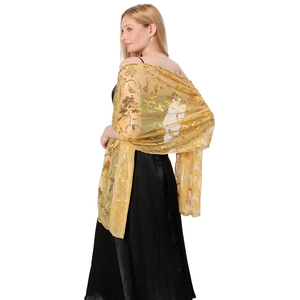 Detail of elegant gold sequin embroidered shawl for wedding or evening gala