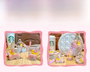 Detail view of liquid quicksand keychain with floating duck and bunny in milk tea bottle