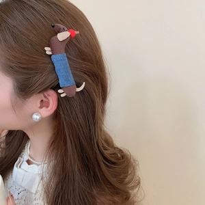 Polka dot fabric dachshund hair clip worn by a model showcasing Korean fashion style