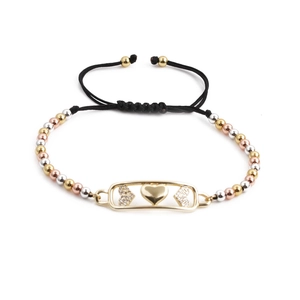Adjustable woven bracelet featuring gold, silver, and rose gold beads with a heart charm