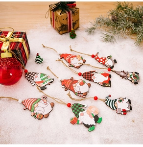 Detailed view of nine wooden Christmas gnome ornaments with red and green festive patterns