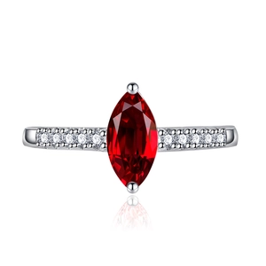 Detailed macro view of a marquise cut red gemstone set in a silver ring with diamonds