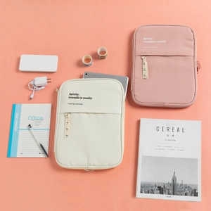 Detail of minimalist cream and pink iPad storage sleeves with cherry pattern ribbon