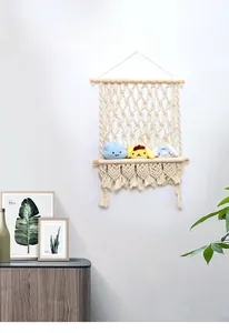 Detailed shot of handmade macrame floating shelf with woven cotton rope and fringe detail