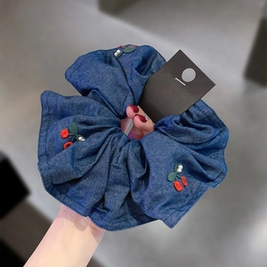 Blue denim scrunchie with red cherry embroidery and pearls for elegant hairstyling