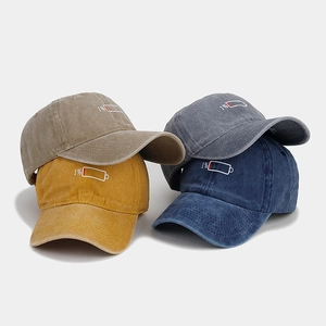 Detail of four washed cotton baseball caps with 1% battery embroidery in multiple colors