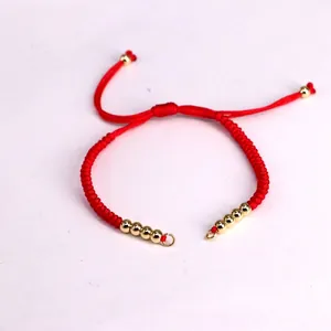 Handmade red woven Milan rope bracelet with golden beads and adjustable sliding clasp
