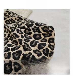 Close-up of leopard print canvas fabric showing detailed texture and jacquard weave