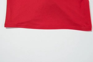 Close-up of red knit dress hemline featuring professional double-needle stitching detail