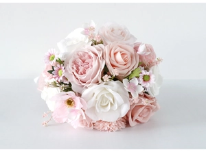 Close-up of silk bridal bouquet featuring pink roses, white peonies and lifelike petals