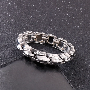 Detailed close-up of retro dragon bone link chain bracelet in silver titanium steel