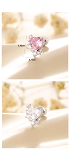 Macro shot of heart-shaped zircon ear studs in pink and clear white titanium steel