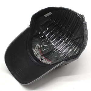 Detail view of cotton baseball cap interior showing 100% cotton tag and fine embroidery