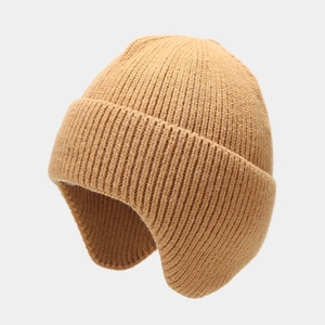 Detail view of camel knit ear protection hat with classic ribbed texture for winter warmth