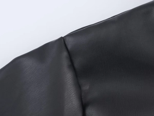 Macro shot of high-quality black faux leather texture and premium stitching detail