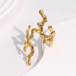 Minimalist gold coral lava ring with organic liquid metal design on stone block