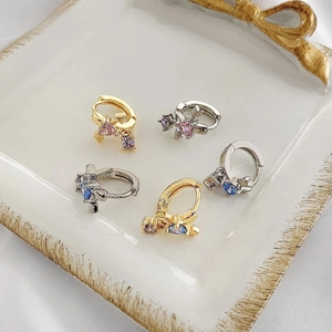 Detail of cupid arrow hoop earrings with heart-shaped pink and blue zircon stones