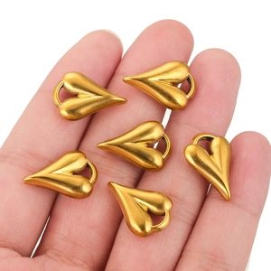 Golden heart pendants in stainless steel for DIY jewelry making held in hand
