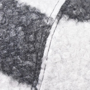 Macro shot of thick sherpa fleece fabric detail with grey and white plaid pattern