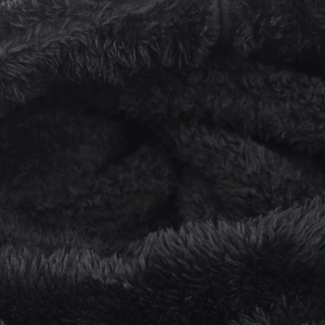 Close-up of thick black faux fur fabric texture for warm outdoor beanies