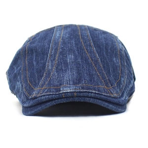 Blue washed denim beret with contrast orange stitching on a clean white background