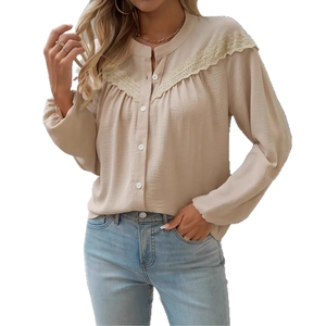 Detail of elegant apricot long sleeve blouse featuring delicate lace stitching on shoulders