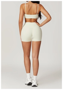Detail view showing back of ivory quick-dry sports bra and high-waisted yoga shorts
