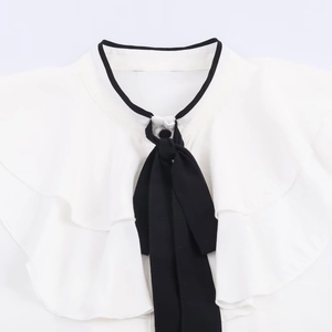 Elegant white shirt featuring black bow tie and ruffle details on the collar