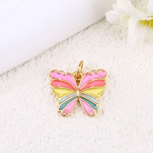 Macro detail of gold-plated butterfly charm with colorful rainbow enamel and top ring
