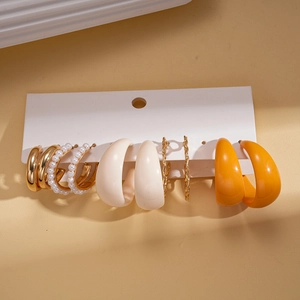 Detail of 10-piece acrylic pearl C-shape hoop earring set displayed on a white card