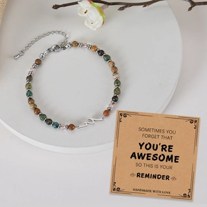 Adjustable natural stone beaded bracelet with silver wave charm on gift card