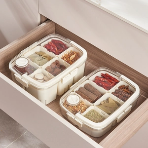 Clear octagonal spice jars with airtight lids organized in a wooden kitchen drawer