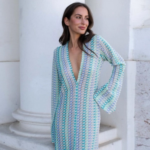 Detail of colorful crochet knit maxi dress featuring intricate hollow pattern and V-neckline