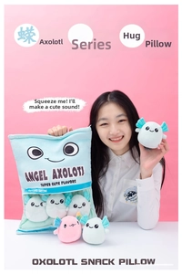 Asian model holding a blue axolotl snack bag plush pillow with colorful mini soft toys