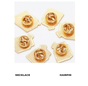 Close-up of bright gold butterfly clutch pin backs with anti-slip texture on white backdrop