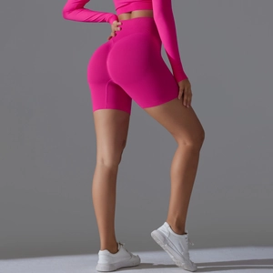 Close-up of high-waist fuchsia yoga shorts featuring seamless ribbed waistband and scrunch butt
