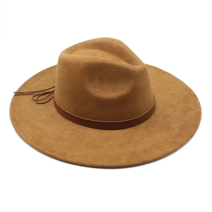 Detail of brown faux suede wide brim fedora with leather band and fringe knot